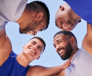 Teamwork, low angle or happy men in huddle with volleyball match strategy for motivation, mission o.